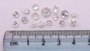 Sixteen loose diamonds.