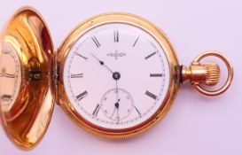An Elgin gold-plated pocket watch. 4 cm diameter.