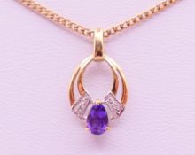 A 9 ct gold amethyst-set pendant on chain. The pendant 1.5 cm high. 4.2 grammes total weight.