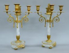 A pair of gilt metal-mounted rock crystal candelabra. Each 38 cm high.