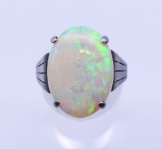 A silver and opal ring. The opal 1.8 cm x 1.2 cm. Ring size S.