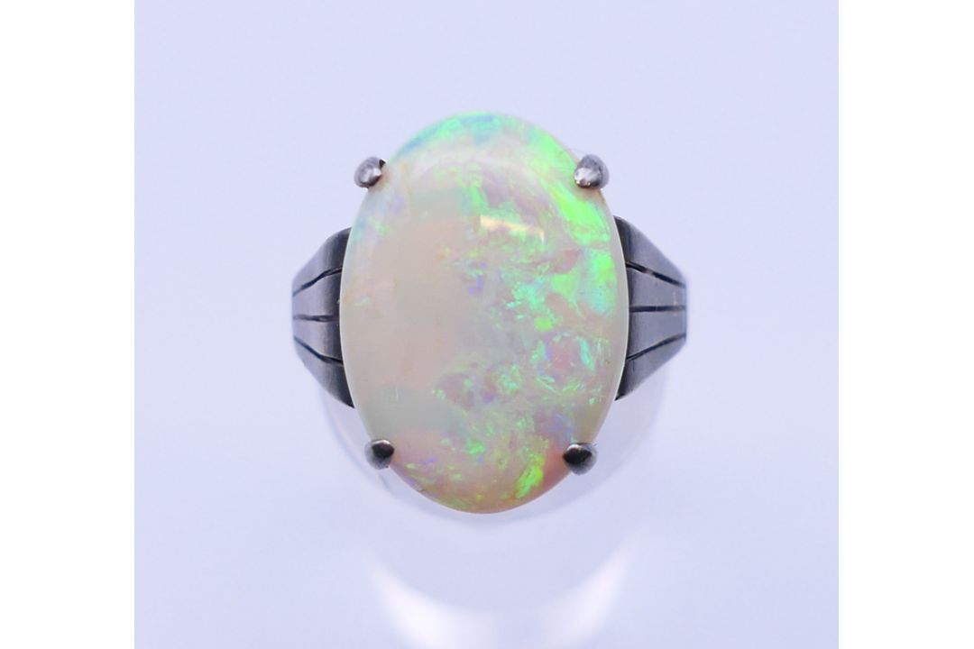 A silver and opal ring. The opal 1.8 cm x 1.2 cm. Ring size S. - Image 1 of 5