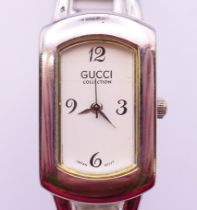 A Gucci ladies' stainless steel wristwatch. 2 cm wide.