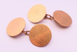 A pair of 9 ct gold cufflinks. Each 1.5 cm diameter. 7.9 grammes.