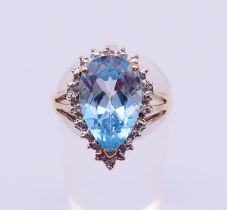 A 9 ct white gold and blue topaz ring. Ring size O.