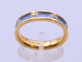 An 18 ct gold diamond and enamel wedding band. Ring size P. 5.6 grammes total weight.