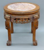 A Chinese marble-topped carved wooden vase stand. 47 cm hhigh.