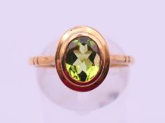A 9 ct gold peridot ring. Ring size Q/R. 2.8 grammes.
