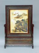 A Chinese table screen with carved wooden surround. 60 cm high.