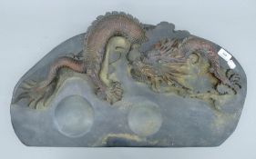 A large Chinese inkstone decorated with a dragon. 70 cm long.