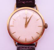 A 9 ct gold Tissot gentlemen's wristwatch. 3.5 cm wide. 30.8 grammes total weight.