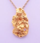 A diamond-set 22 ct gold nugget pendant on an unmarked chain. The pendant 4 cm high. 46.