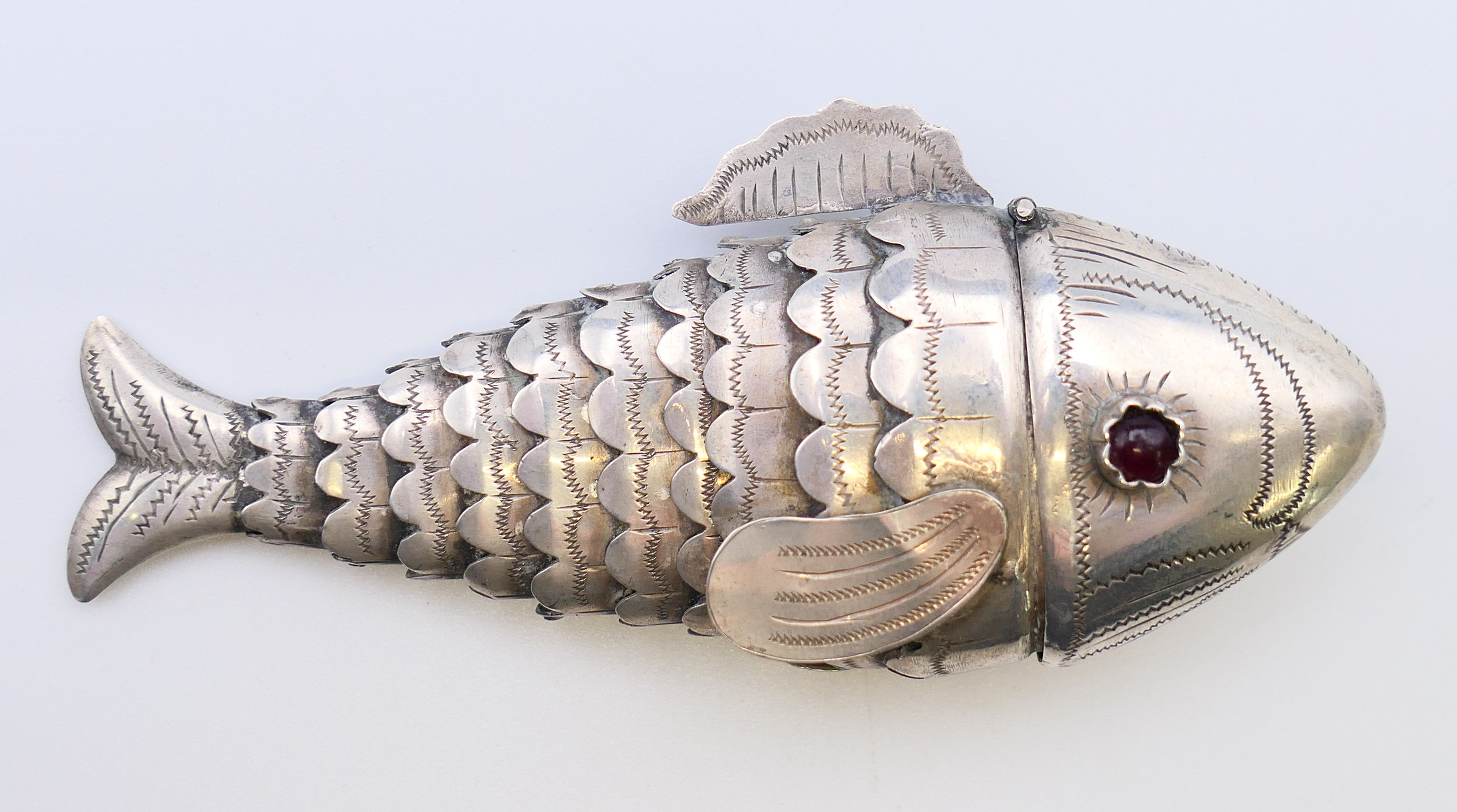 An eastern unmarked silver reticulated fish-form pill box. 9 cm long.