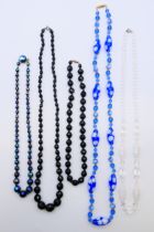 Three vintage black glass necklaces,