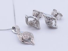 A 9 ct white gold diamond-set pendant necklace and a pair of earrings. The pendant 1.5 cm high. 2.