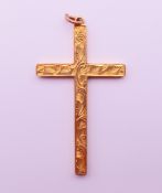 A 9 ct gold cross-form pendant. 4.5 cm high. 1.3 grammes.