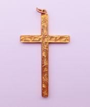 A 9 ct gold cross-form pendant. 4.5 cm high. 1.3 grammes.