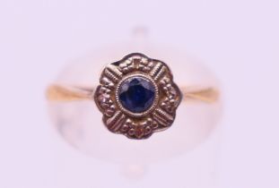 A gold and platinum diamond and sapphire flowerhead ring. Ring size K.