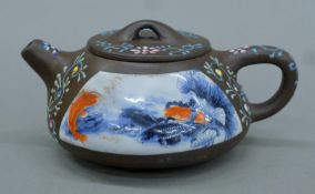 A Chinese painted Yixing teapot. 17 cm long.