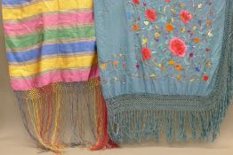 An embroidered teal-coloured shawl and another striped shawl. The former 160 x 160 cm.