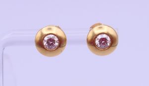 A pair of 18 ct gold and diamond ear studs, each stone approximately 0.25 ct. Each 8 mm diameter. 3.
