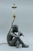 A Burmese bronze of a seated musician adapted as a table lamp. 58 cm high overall.