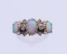 A 9 ct gold, opal and diamond ring. Ring size O/P.