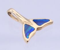 A 14 K gold and black opal fish tail pendant. 2 cm high. 2 grammes total weight.