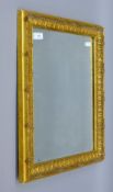 A gilt-framed bevelled mirror. 53.5 x 43.5 cm.