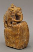 A Chinese stone carving of an Asian elephant with attendant astride. 19 cm high.