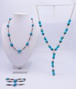 Two white metal and blue bead necklaces, one with some detached links. 45 cm long and 60 cm long.