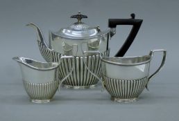 A Victorian three-piece silver tea set. The teapot 25 cm high. 24.5 troy ounces.