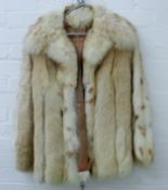 Three fur coats, one with a matching hat.