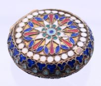 A silver and enamel pill box. 4.25 cm diameter.