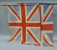 Two Union flags, each mounted on a pole. The poles 195 cm long.