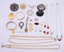A quantity of costume jewellery to include an agate brooch, a bog-oak mourning brooch,