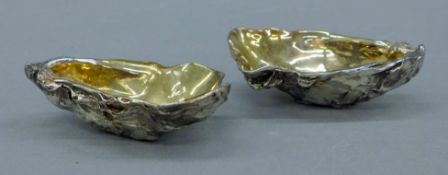 A pair of silver-plated oyster shell-form salts. Each 9.5 cm long.