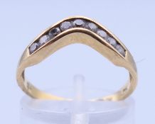 An 18 ct gold diamond channel set ring. Ring size N.