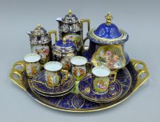 A quantity of Vienna porcelain, including a coffee set on tray. The tray 42 cm wide.