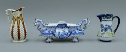 A Macintyre porcelain jug, a Delft vase and a W B Cobridge fern pattern jug. The latter 18 cm high.