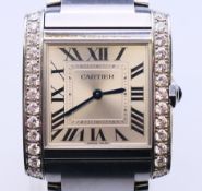 A boxed Cartier ladies' 'Tank Francaise' diamond-set stainless steel wristwatch together with