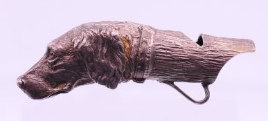 A silver whistle formed as the head of an English Setter, hallmarked for London 1989. 7 cm long.