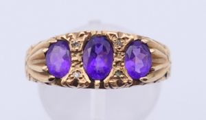 A 9 ct gold, amethyst and diamond ring. Ring size S/T. 3.3 grammes total weight.