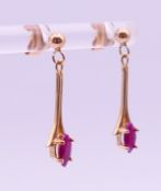 A pair of 9 ct gold ruby earrings. 2.5 cm high.