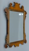 Three 19th century mahogany-framed wall glasses. The largest 43 x 68 cm.