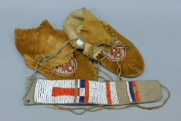 A pair of Cree Indian moccasins and a beaded belt. The latter 39 cm long.
