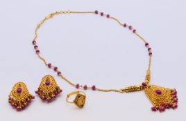 An Indian 22 ct gold gem-set wedding jewellery set comprising pendant necklace,