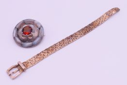 An unmarked silver Scottish Montrose agate brooch/pendant and a silver bangle formed as a belt and