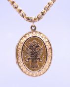 A 9 ct gold and gold plate locket with double headed eagle emblem on one side and a shield with