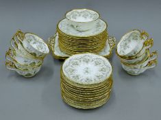 A Cauldon gilt-rimmed porcelain tea set with grape vine decoration.